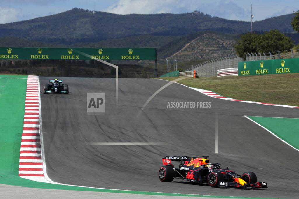 Manu Fernandez Red Bull driver Max Verstappen of the Netherlands takes a curve followed by Mercedes driver Valtteri Bottas of Finland, left, during the qualifying session ahead of the Portugal Formula One Grand Prix at the Algarve International Circuit near Portimao, Portugal, Saturday, May 1, 2021. The Portugal Grand Prix will be held on Sunday. (AP Photo/Manu Fernandez)