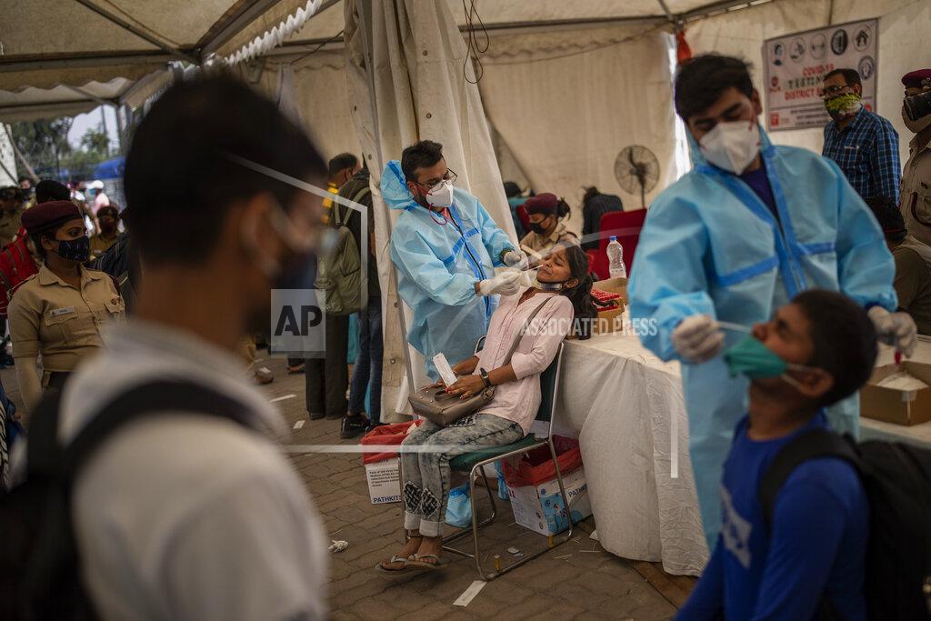 Altaf Qadri Health workers take nasal swab samples of passengers to test for COVID-19 at a bus terminal in New Delhi, India, Wednesday, March 24, 2021. (AP Photo/Altaf Qadri)
