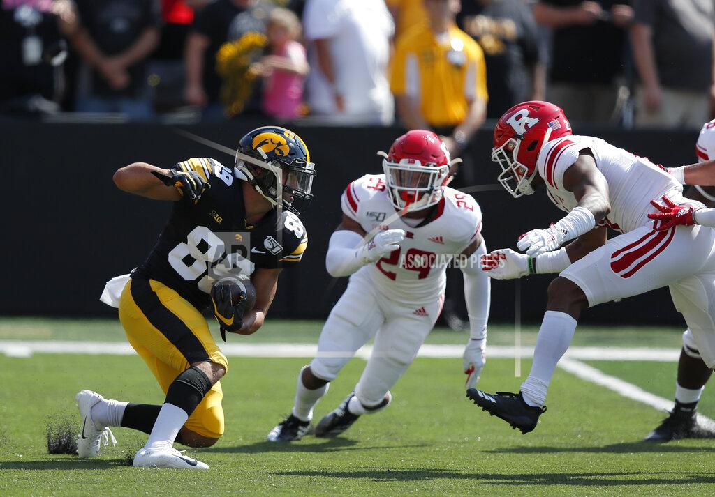 Matthew Putney Iowa wide receiver Nico Ragaini, left, runs the ball on a kickoff return as Rutgers defensive backs Lawrence Stevens, center, and Tre Avery, right, defend during the first half of an NCAA college football game, Saturday, Sept. 7, 2019, in Iowa City. (AP Photo/Matthew Putney)