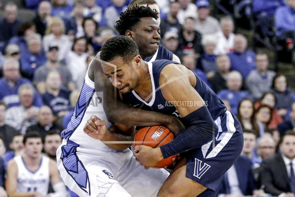 Villanova's Phil Booth, front, and Creighton's Kaleb Joseph, rear, struggle for the ball during the second half of an NCAA college basketball game in Omaha, Neb., Sunday, Jan. 13, 2019. (AP Photo/Nati Harnik)