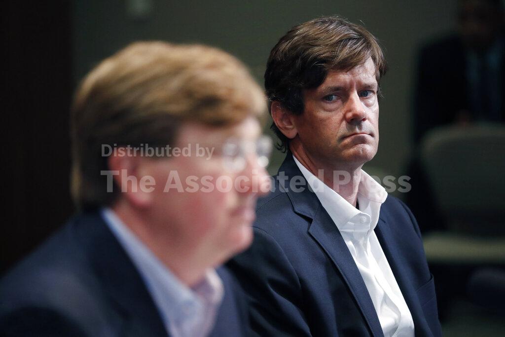 State Health Officer Dr. Thomas Dobbs, right, listens as Republican Gov. Tate Reeves lessens a number of social and business restrictions from previous executive orders dealing with the early days of COVID-19, during his daily update Monday, May 4, 2020, in Jackson, Miss. (AP Photo/Rogelio V. Solis)