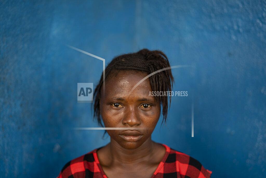 Leo Correa Kadiatu poses for a portrait in Lei chiefdom, district of Kono, Sierra Leone, Friday, Nov. 27, 2020. The 15-year-old she says her widowed mother pushed her into marriage during the pandemic because of financial hardship and because the teenager's prospects for a husband already were considered limited as she had gotten pregnant once before at 12. She can’t be sure just how much money was offered as a bride price: She was crying too hard at the ceremony to see straight. “I was not ready to get married. I wanted to learn something first,” she says. (AP Photo/Leo Correa)