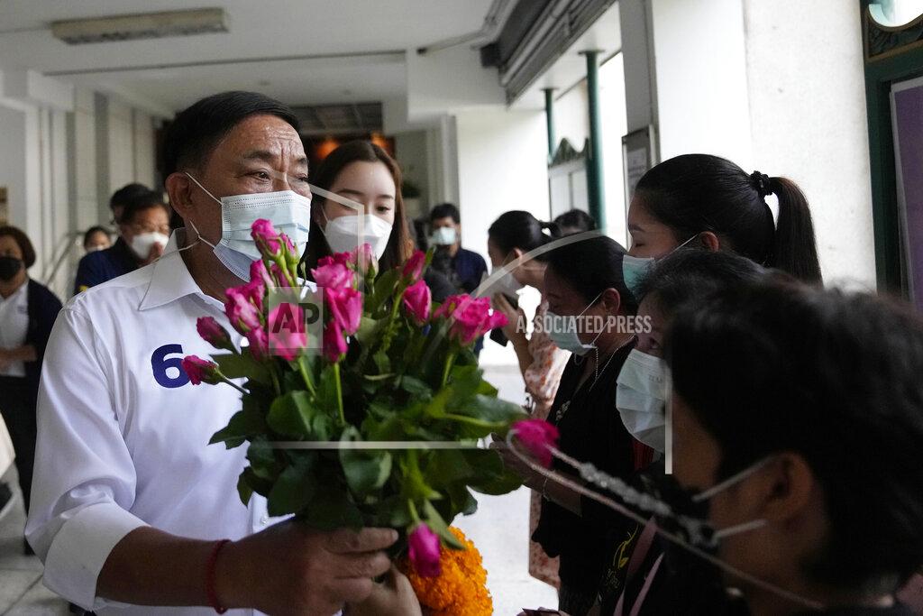 Sakchai Lalit Bangkok governor independent candidate Asawin Kwanmuang received flower from his supporters during an election campaign in Bangkok, Thailand, Tuesday, May 17, 2022. Residents of the Thai capital Bangkok will cast their ballots for the city’s leader Sunday in a vote seen as a barometer of the public mood ahead of an approaching general election. (AP Photo/Sakchai Lalit)