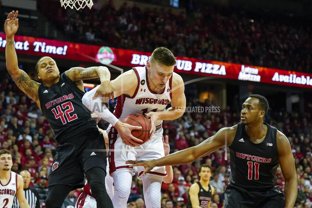 Andy Manis Wisconsin's Micah Potter, center, grabs a defensive rebound against Rutgers' Jacob Young (42) and Mamadou Doucoure, right, during the first half of an NCAA college basketball game Sunday, Feb. 23, 2020, in Madison, Wis. (AP Photo/Andy Manis)