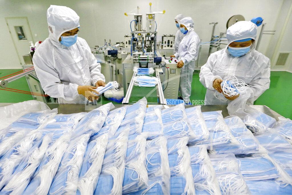 Uncredited FILE - In this Feb. 7, 2020 file photo, workers pack surgical masks at a factory in Suining city in southwest China's Sichuan province. China won't restrict exports of medical goods needed to fight the coronavirus pandemic, a government spokesman said Thursday, April 16, 2020, amid global tension over scarce masks and ventilators. (Chinatopix via AP, File)