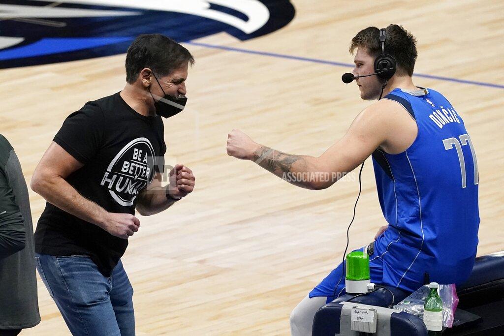 Tony Gutierrez Dallas Mavericks team owner Mark Cuban, left, celebrates with Luka Doncic, right, as Doncic participates in a broadcast interview after their 118-117 win in an NBA basketball game against the Atlanta Hawks in Dallas, Wednesday, Feb. 10, 2021. (AP Photo/Tony Gutierrez)