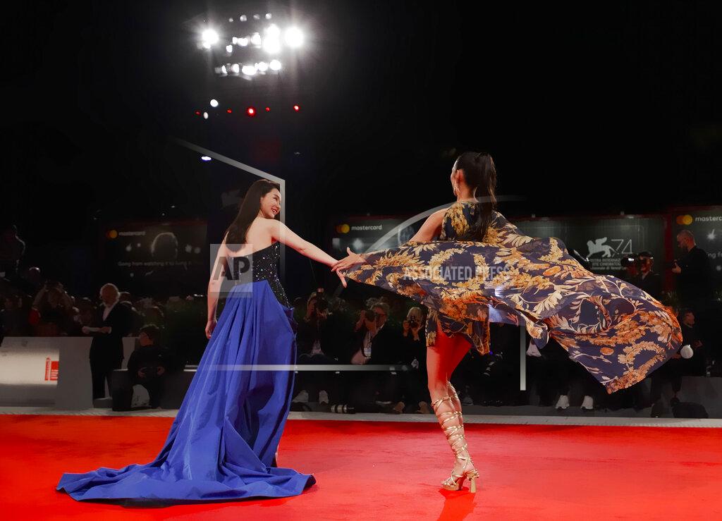 Domenico Stinellis File - Actresses Qi Wei, left, and Tao Okamoto pose for photographers at the premiere for the film "Zhuibu" (Manhunt) at the Venice Film Festival. The 77th Venice Film Festival will kick off on Wednesday, Sept. 2, 2020, but this year's edition will be unlike any others. Coronavirus restrictions will mean fewer Hollywood stars, no crowds interacting with actors and other virus safeguards will be deployed. (AP Photo/Domenico Stinellis, File)