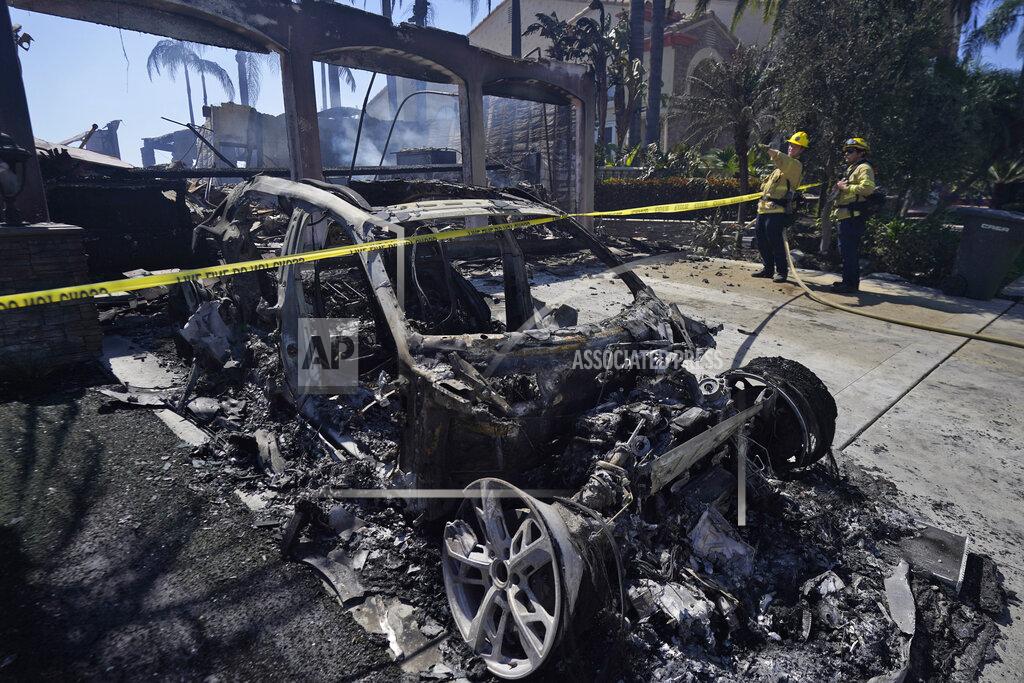Marcio Jose Sanchez Firefighters monitor hot spots next to a car destroyed by the Coastal Fire Thursday, May 12, 2022, in Laguna Niguel, Calif. (AP Photo/Marcio Jose Sanchez)
