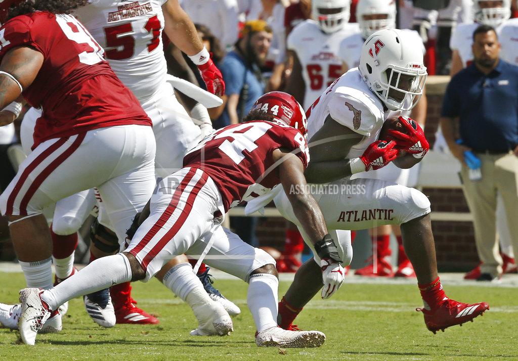 Sue Ogrocki Florida Atlantic running back Devin Singletary (5) carries around Oklahoma defensive back Brendan Radley-Hiles (44) in the first half of an NCAA college football game in Norman, Okla., Saturday, Sept. 1, 2018. (AP Photo/Sue Ogrocki)