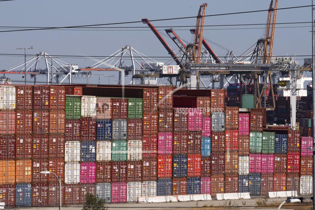 Damian Dovarganes Cargo containers sit stacked at the Port of Los Angeles in San Pedro, Calif., Tuesday, Oct. 19, 2021. California Gov, Gavin Newsom on Wednesday issued an order that aims to ease bottlenecks at the ports of Los Angeles and Long Beach. The order directs California agencies to look for state-owned properties that could temporarily store goods coming into the ports. (AP Photo/Damian Dovarganes)