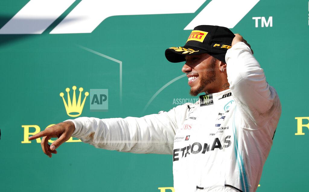 Mercedes driver Lewis Hamilton of Britain celebrates on the podium after winning the Hungarian Formula One Grand Prix at the Hungaroring racetrack in Mogyorod, northeast of Budapest, Hungary, Sunday, Aug. 4, 2019. (AP Photo/Laszlo Balogh)