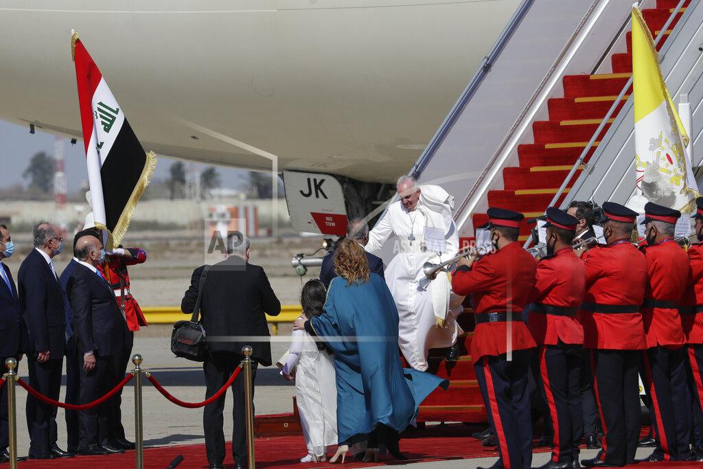 Andrew Medichini Pope Francis arrives at Baghdad's international airport, Iraq, Friday, March 5, 2021. Pope Francis heads to Iraq on Friday to urge the country's dwindling number of Christians to stay put and help rebuild the country after years of war and persecution, brushing aside the coronavirus pandemic and security concerns. (AP Photo/Andrew Medichini)