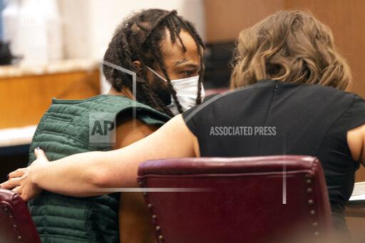 Darrell Brooks, left, speaks with a lawyer during his initial appearance, Tuesday, Nov. 23, 2021 in Waukesha County Court in Waukesha, Wis. Prosecutors in Wisconsin have charged Brooks with intentional homicide in the deaths of at least five people who were killed when an SUV was driven into a Christmas parade. (Mark Hoffman/Milwaukee Journal-Sentinel via AP, Pool)