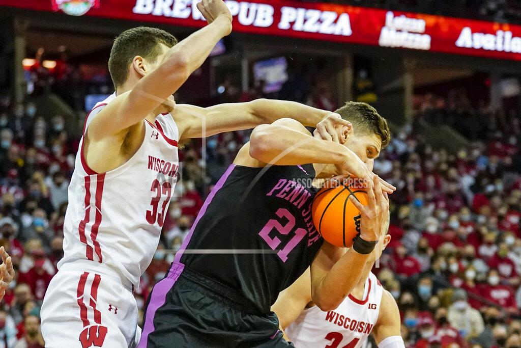 Andy Manis Penn State's John Harrar (21) grabs an offensive rebound against Wisconsin's Chris Vogt (33) during the first half of an NCAA college basketball game Saturday, Feb. 5, 2022, in Madison, Wis. (AP Photo/Andy Manis)