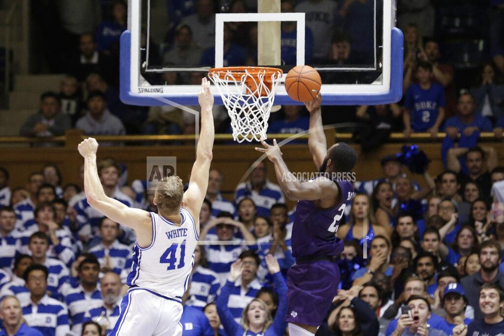 Gerry Broome FILE - Stephen F. Austin forward Nathan Bain (23) drives for the game-winning basket against Duke forward Jack White (41) during overtime in an NCAA college basketball game in Durham, N.C., in this Tuesday, Nov. 26, 2019, file photo. Bain provided one of college basketball’s signature moments last season, a buzzer-beating layup in overtime to give unheralded Stephen F. Austin a stunning upset over Duke. But that became just a sliver of the story that night. His layup won a game -- and rebuilt a home, rebuilt a school and rebuilt a church, all of it directly impacting the lives of hundreds of Bahamians who have dealt with enormous challenges for the last 14 months and counting. (AP Photo/Gerry Broome, File)