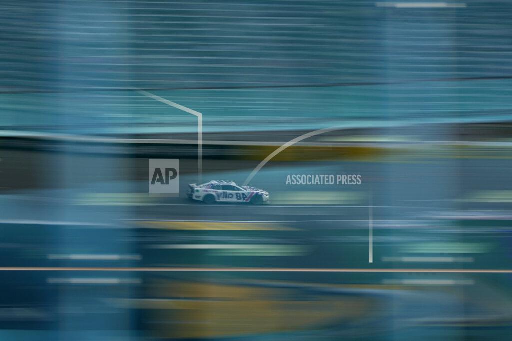 John Locher Alex Bowman (48) is reflected in a window as he races during a NASCAR Cup Series auto race Sunday, March 6, 2022, in Las Vegas. (AP Photo/John Locher)