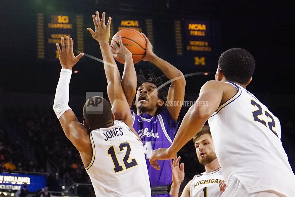 Carlos Osorio Tarleton State guard Tahj Small (4) shoots over the defense of Michigan guard DeVante' Jones (12) during the first half of an NCAA college basketball game, Wednesday, Nov. 24, 2021, in Ann Arbor, Mich. (AP Photo/Carlos Osorio)