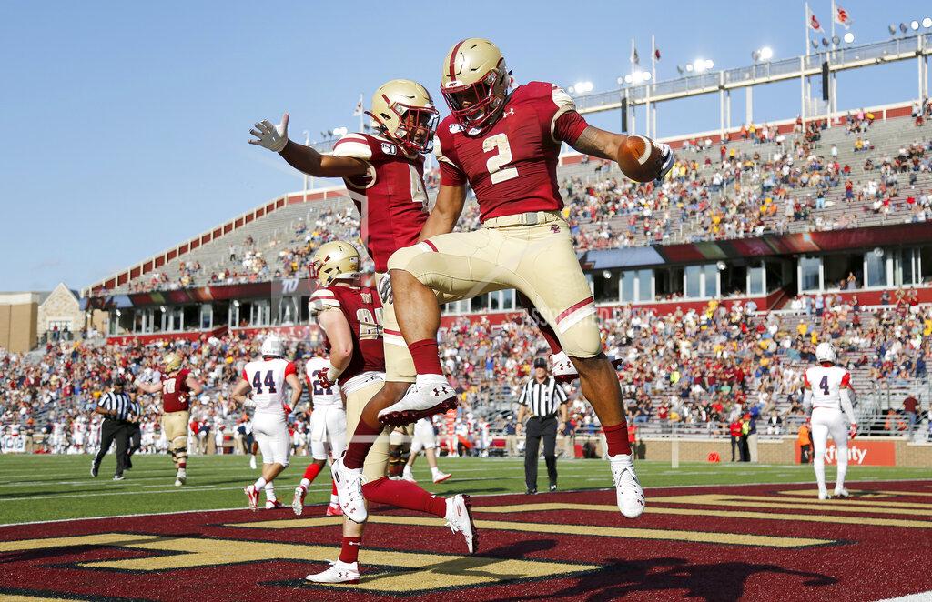 Mary Schwalm Boston College running back AJ Dillon (2) celebrates with teammate Zay Flowers (4) after scoring a touchdown during the first half of an NCAA college football game against Richmond, Saturday, Sept. 7, 2019, in Boston. (AP Photo/Mary Schwalm)