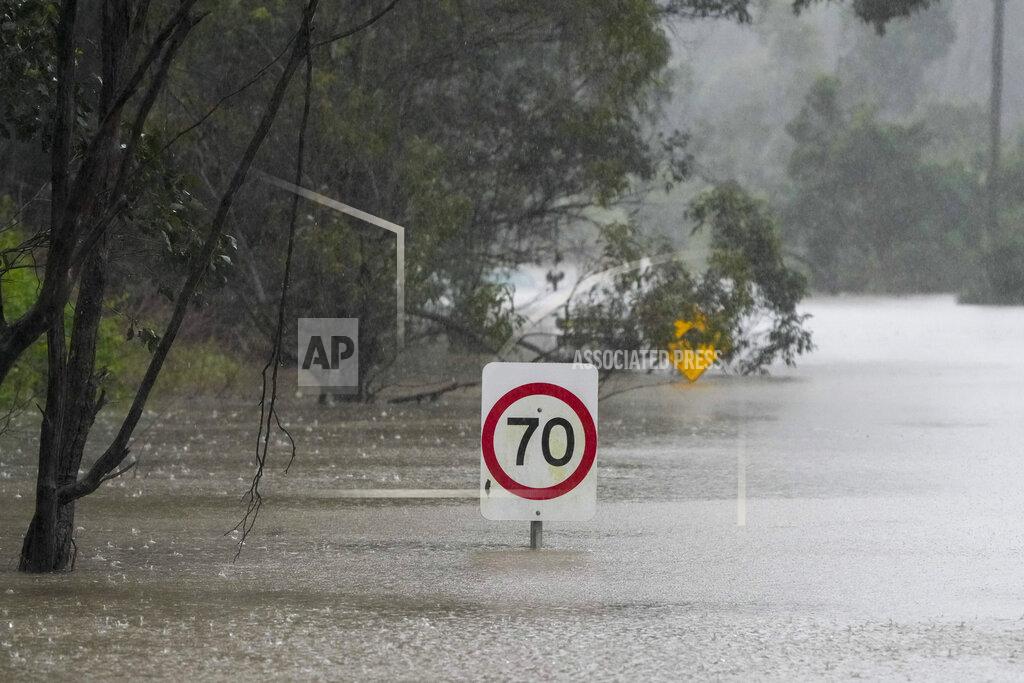 Mark Baker Traffic signs sit submerged along a flooded road in Londonderry on the outskirts of Sydney, Australia, Monday, July 4, 2022. More than 30,000 residents of Sydney and its surrounds have been told to evacuate or prepare to abandon their homes on Monday as Australia's largest city braces for what could be its worst flooding in 18 months. (AP Photo/Mark Baker)