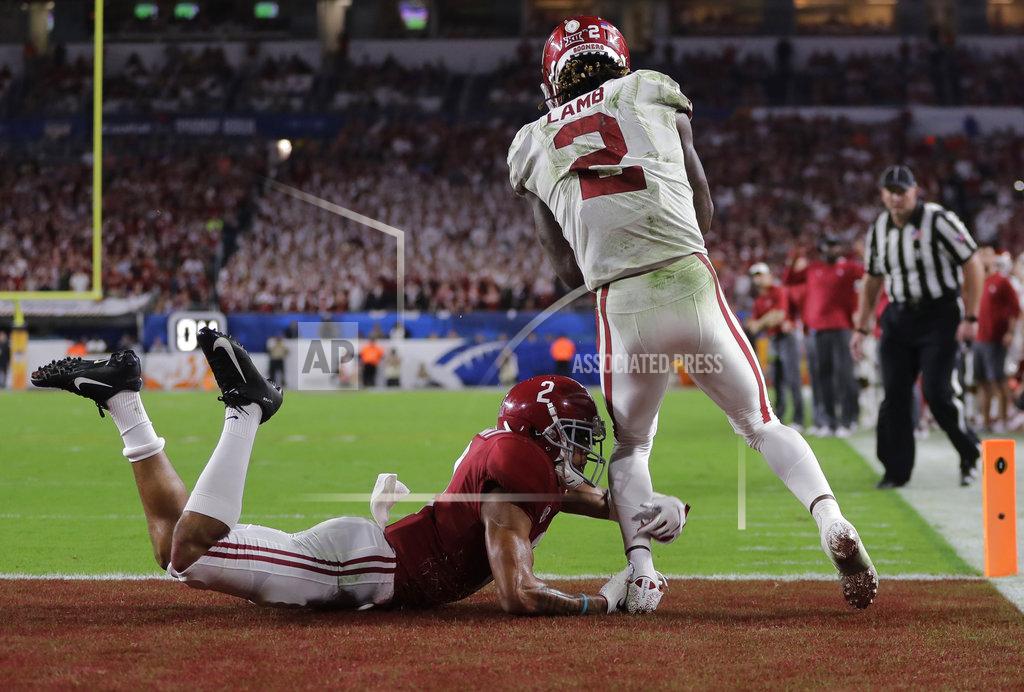 Lynne Sladky Oklahoma wide receiver CeeDee Lamb (2) scores a touchdown as Alabama defensive back Patrick Surtain II (2) grabs his leg, during the second half of the Orange Bowl NCAA college football game, Saturday, Dec. 29, 2018, in Miami Gardens, Fla. (AP Photo/Lynne Sladky)