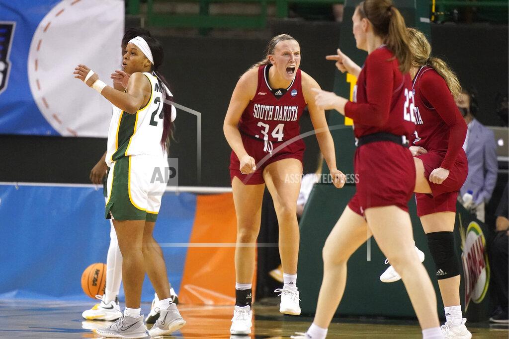 Lm Otero South Dakota center Hannah Sjerven (34) yells and looks to teammates in front of Baylor guard Sarah Andrews (24) during the first half of a college basketball game in the second round of the NCAA tournament in Waco, Texas, Sunday, March 20, 2022. South Dakota 63-57. (AP Photo/LM Otero)