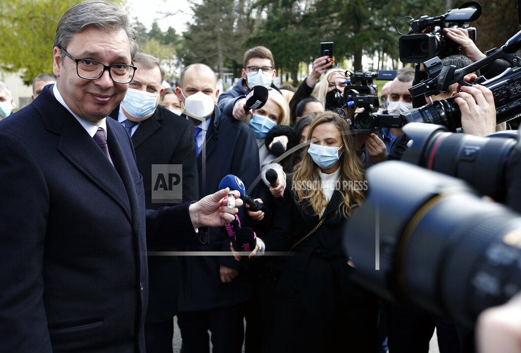 Darko Vojinovic Serbian President Aleksandar Vucic poses with a vial of the Sputnik V in Belgrade, Serbia, Thursday, April 15, 2021. Serbia has announced it will begin packing and later producing Russia's Sputnik V coronavirus vaccine, which would make it the first European state outside Russia and Belarus to begin manufacturing the jab. (AP Photo/Darko Vojinovic)