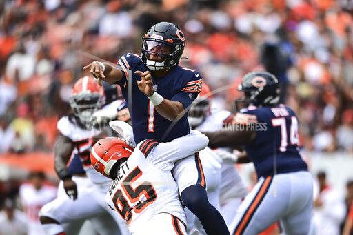 Chicago Bears quarterback Justin Fields (1) is hit by Chicago Bears defensive tackle Khyiris Tonga (95) after a pass during the second half of an NFL football game, Sunday, Sept. 26, 2021, in Cleveland. (AP Photo/David Dermer)