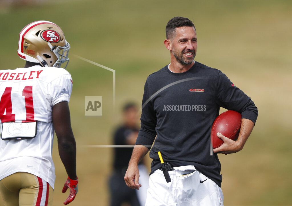 David Zalubowski FILE - In this Aug. 16, 2019, file photo, San Francisco 49ers head coach Kyle Shanahan, right, jokes with cornerback Emmanuel Moseley during a combined NFL football training camp with the Denver Broncos at the Broncos' headquarters in Englewood, Colo. Commissioner Roger Goodell told the 32 NFL clubs on Thursday, June 4, 2020, that coaching staffs are allowed to return to team facilities starting Friday. (AP Photo/David Zalubowski, File)