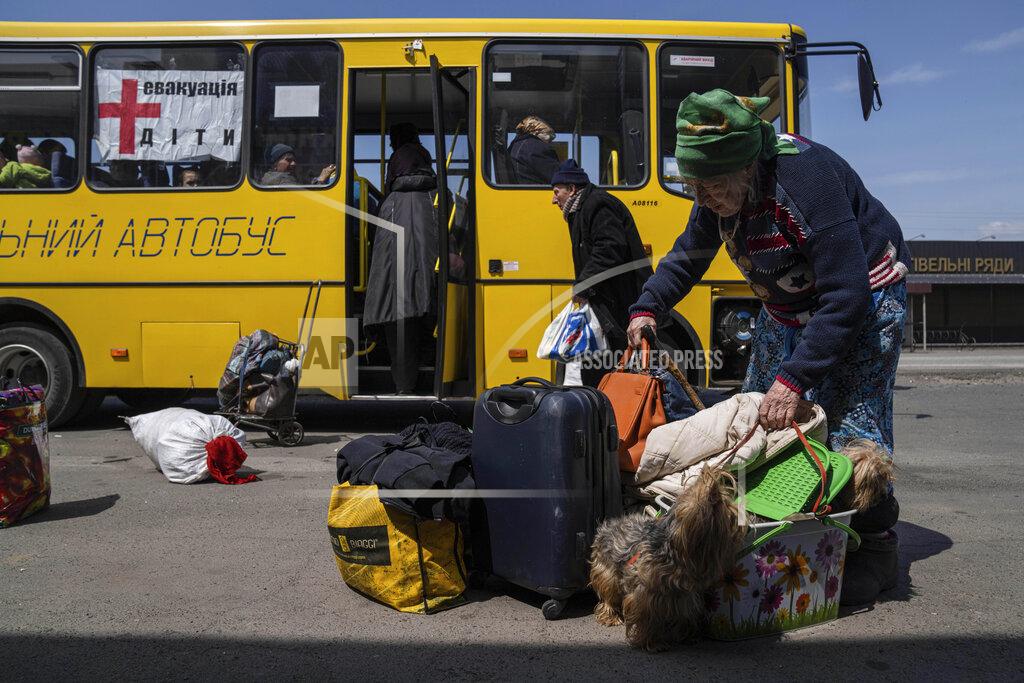Evgeniy Maloletka A woman from Siversk carries her belongings during an evacuation near Lyman, Ukraine, Wednesday, May 11, 2022. (AP Photo/Evgeniy Maloletka)