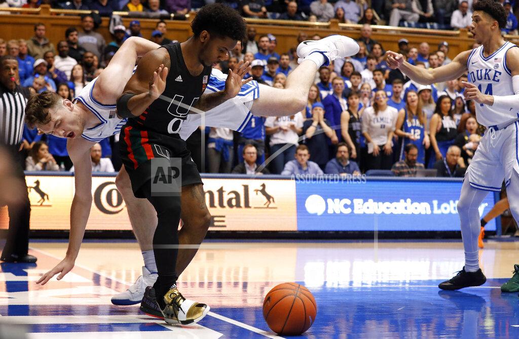 Gerry Broome Duke forward Matthew Hurt falls out-of-bounds while chasing the ball with Miami guard Chris Lykes (0) during the first half of an NCAA college basketball game in Durham, N.C., Tuesday, Jan. 21, 2020. (AP Photo/Gerry Broome)