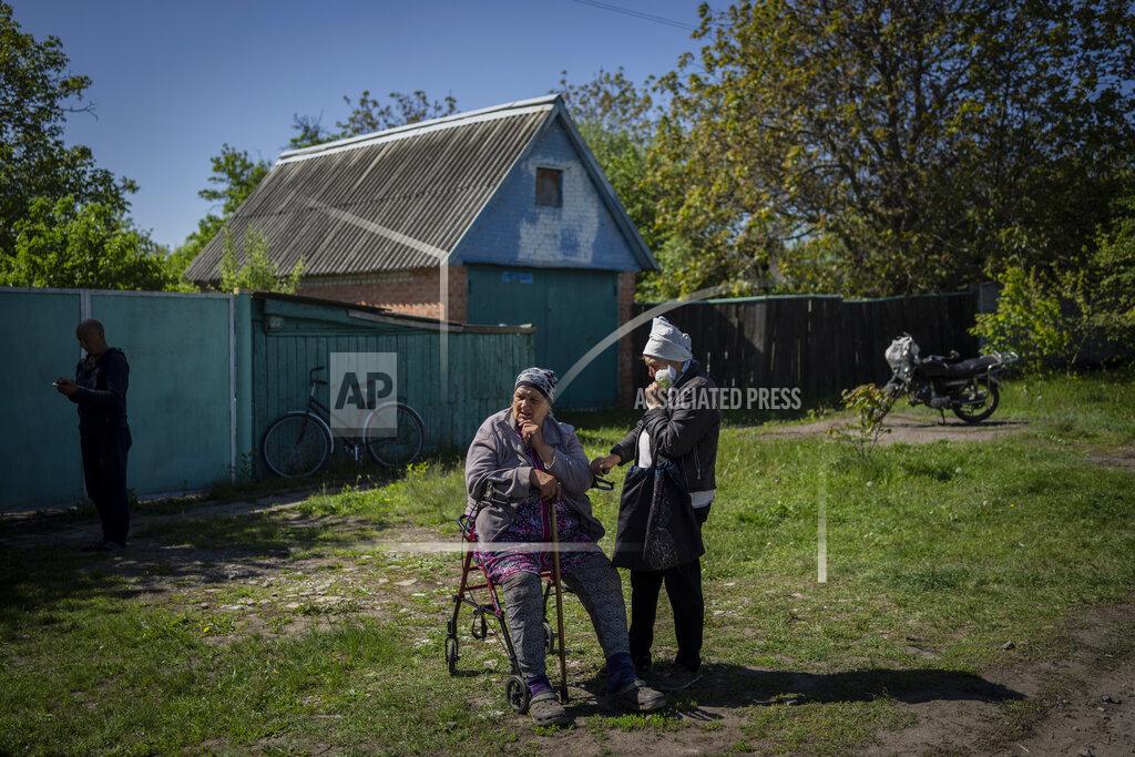 Bernat Armangue Villagers wait for aid distribution by Kharkiv's Red Cross in the village of Staryi Saltiv, east Kharkiv, Ukraine, Friday, May 20, 2022. The village formerly occupied by Russian forces is back under Ukrainian control, albeit very close to the front line and under constant shelling. (AP Photo/Bernat Armangue)