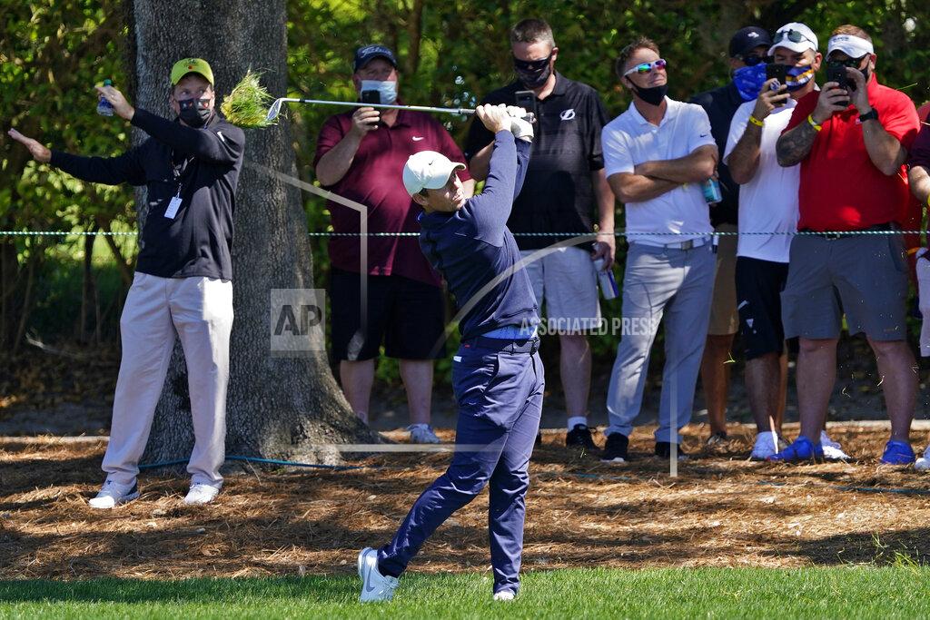 John Raoux Rory McIlroy, of Northern Ireland, hits from the rough in front of the gallery on the ninth hole during the first round of the Arnold Palmer Invitational golf tournament Thursday, March 4, 2021, in Orlando, Fla. (AP Photo/John Raoux)