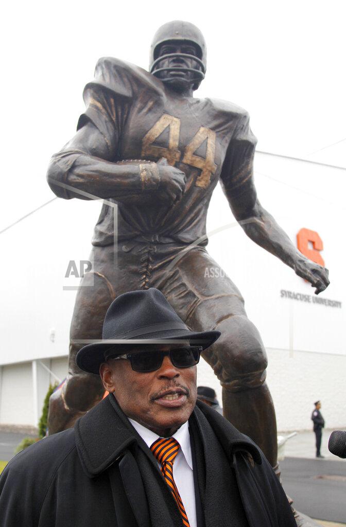 Nick Lisi FILE - In this Nov. 14, 2015 file photo, Floyd Little, stands next to a statue of himself dedicated during a ceremony on the Syracuse University campus in Syracuse, N.Y. Little, the Hall of Fame running back who starred at Syracuse and for the Denver Broncos, has died. The Pro Football Hall of Fame said he died Friday, Jan. 1, 2021. (AP Photo/Nick Lisi)