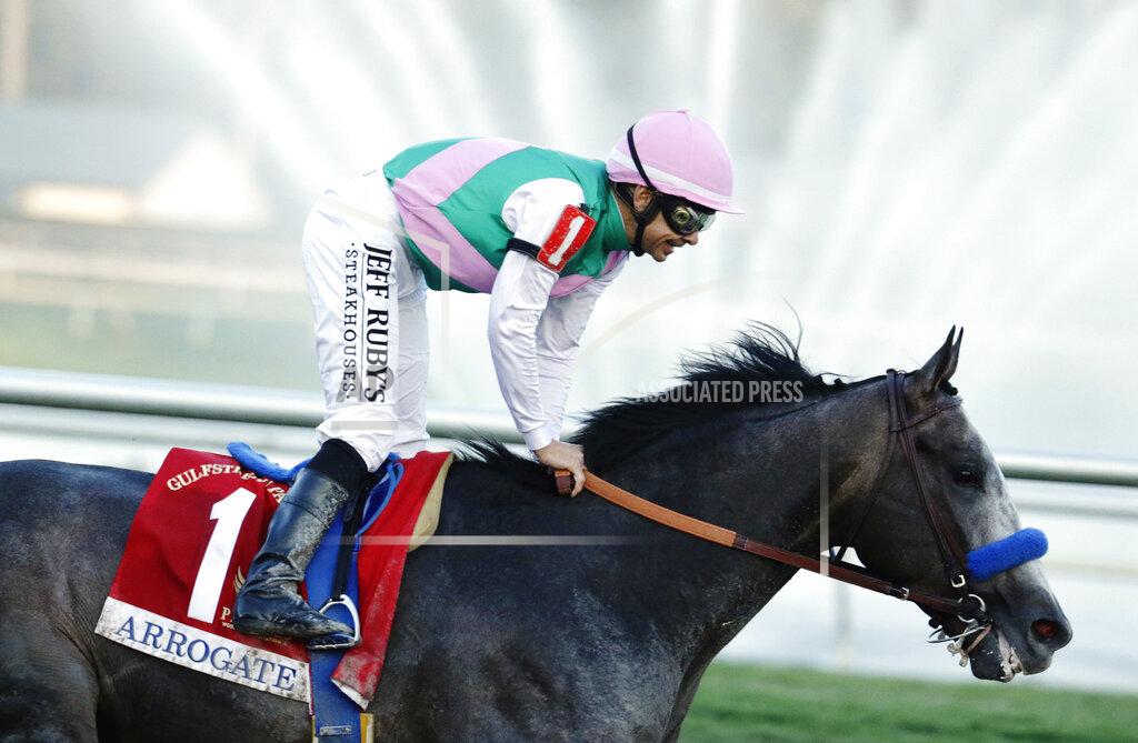 Lynne Sladky FILE - In this Jan. 28, 2017, file photo, jockey Mike Smith stands up in the saddle after riding Arrogate to win the inaugural running of the $12 million Pegasus World Cup horse race at Gulfstream Park in Hallandale Beach, Fla. Arrogate, winner of the 2016 Breeders’ Cup Classic and the champion 3-year-old male that year on his way to becoming North America’s all-time leading money earner, has died. He was seven. Juddmonte Farms said Arrogate was euthanized Tuesday, June 2, 2020, after becoming ill.(AP Photo/Lynne Sladky, File)