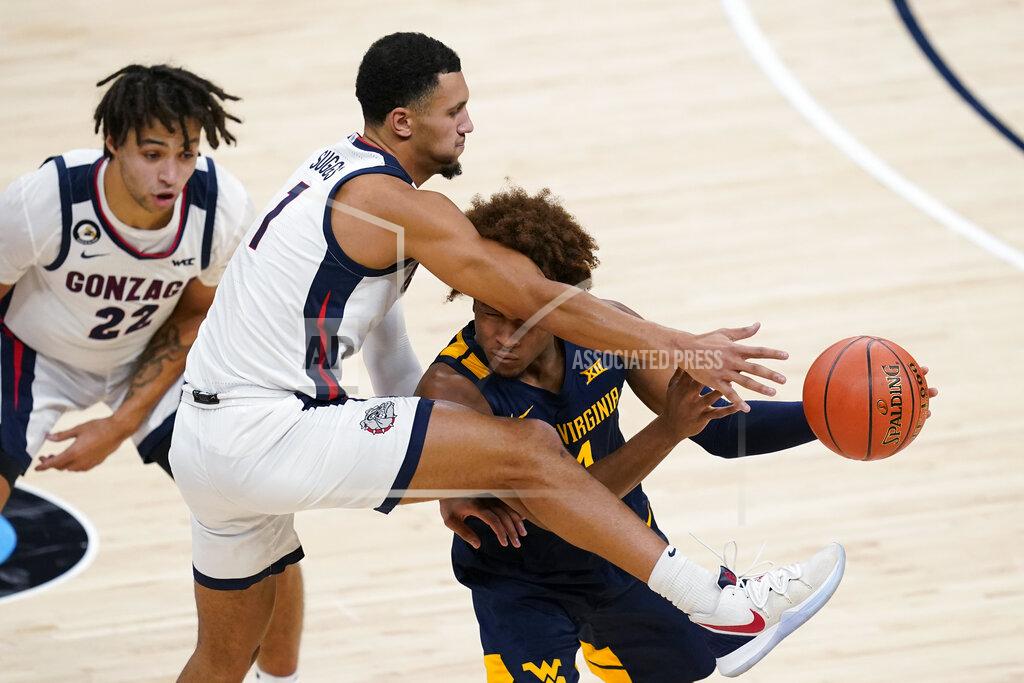 Darron Cummings West Virginia's Miles McBride (4) makes a pass while being defended by Gonzaga's Jalen Suggs (1) during the first half of an NCAA college basketball game Wednesday, Dec. 2, 2020, in Indianapolis. (AP Photo/Darron Cummings)