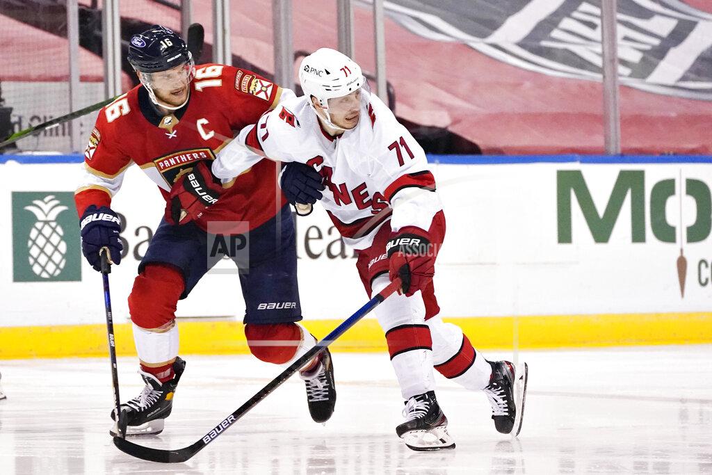 Wilfredo Lee Florida Panthers center Aleksander Barkov (16) and Carolina Hurricanes right wing Jesper Fast (71) battle for position during the second period of an NHL hockey game, Monday, March 1, 2021, in Sunrise, Fla. (AP Photo/Wilfredo Lee)