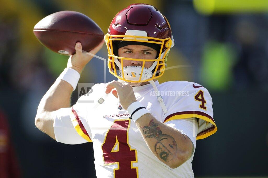 Aaron Gash Washington Football Team's Taylor Heinicke warms up before an NFL football game against the Green Bay Packers Sunday, Oct. 24, 2021, in Green Bay, Wis. (AP Photo/Aaron Gash)