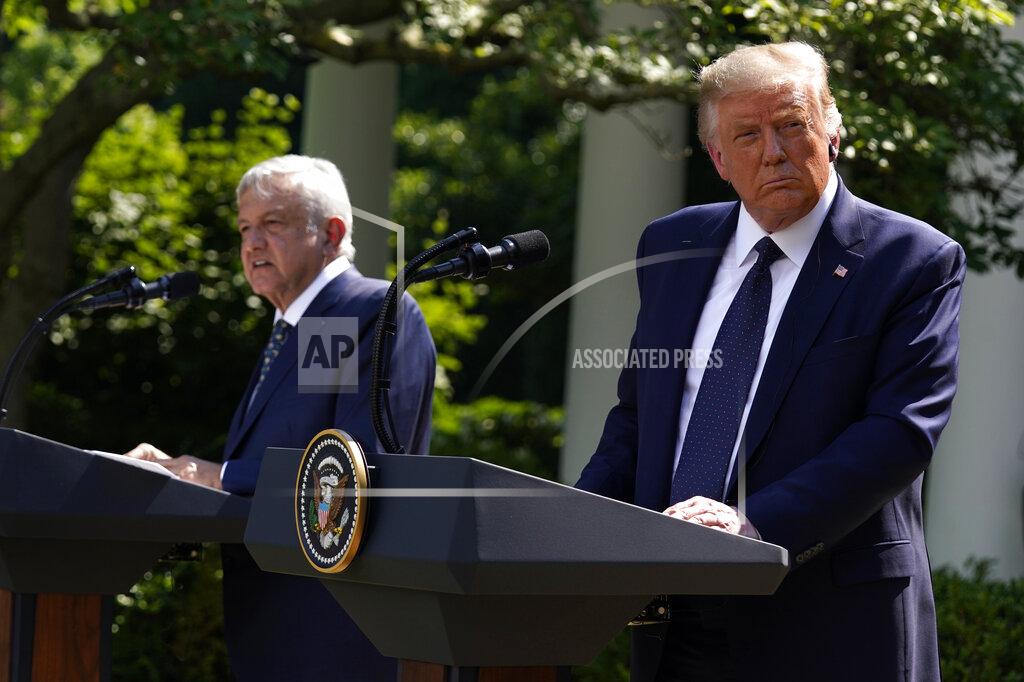 Evan Vucci President Donald Trump listens as Mexican President Andres Manuel Lopez Obrador speaks during an event in the Rose Garden at the White House, Wednesday, July 8, 2020, in Washington. (AP Photo/Evan Vucci)