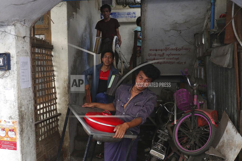 Uncredited State railway employees carry their belongings after being evicted from their home Saturday, March 20, 2021, in Mandalay, Myanmar. State railway workers in Mandalay have been threatened with eviction to force them to end their support for the Civil Disobedience Movement (CDM) against military rule. (AP Photo)
