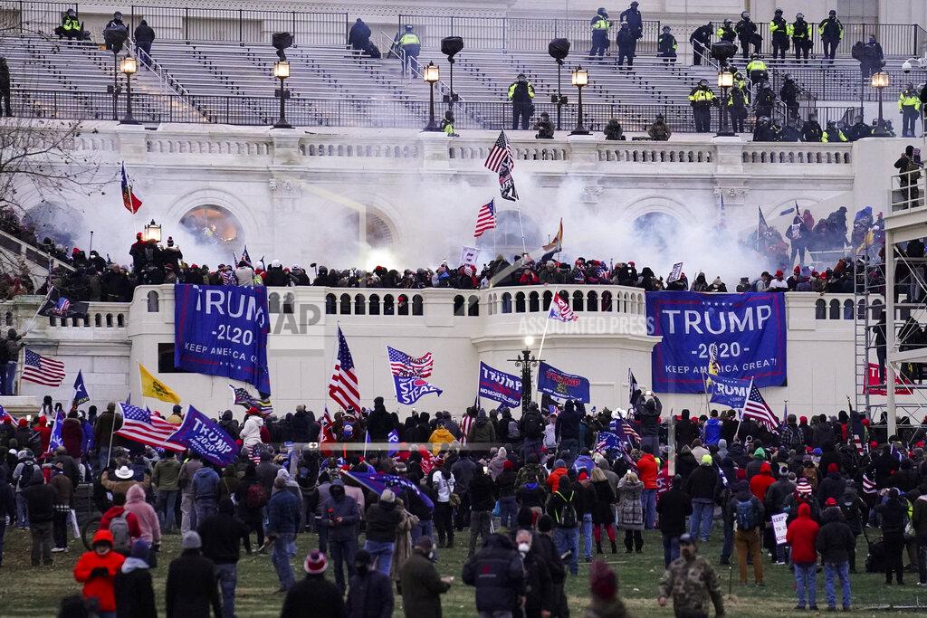 Violent protesters, loyal to President Donald Trump, storm the Capitol, Wednesday, Jan. 6, 2021, in Washington. It's been a stunning day as a number of lawmakers and then the mob of protesters tried to overturn America's presidential election, undercut the nation's democracy and keep Democrat Joe Biden from replacing Trump in the White House. (AP Photo/John Minchillo)