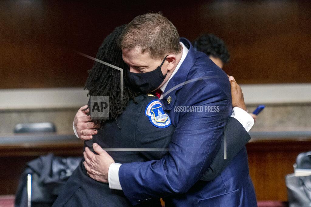 Andrew Harnik Former U.S. Capitol Police Chief Steven Sund, right, hugs Capitol Police Captain Carneysha Mendoza, left, before they testify before a Senate Homeland Security and Governmental Affairs & Senate Rules and Administration joint hearing on Capitol Hill, Washington, Tuesday, Feb. 23, 2021, to examine the January 6th attack on the Capitol. (AP Photo/Andrew Harnik, Pool)