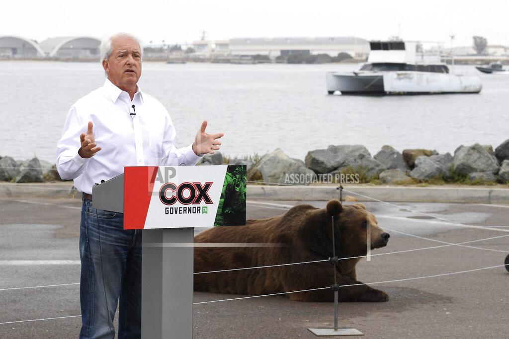 Denis Poroy File -- In this May 11, 2021, file photo California gubernatorial candidate John Cox speaks in front of his Kodiak bear at a campaign event held on Shelter Island in San Diego. Cox, a Republican, is among the more than three dozen people who have filed the required paperwork to run in the Sept. 14 recall election that could remove Gov. Gavin Newsom from office. (AP Photo/Denis Poroy, File)