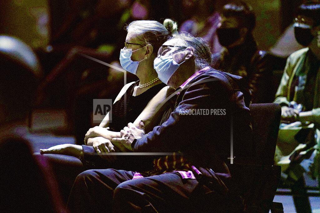 Kathy Willens A man and woman listen to a concert by the New York Philharmonic, which performed before a live audience for the first time since March 10, 2020, at The Shed in Hudson Yards, Wednesday, April 14, 2021, in New York. (AP Photo/Kathy Willens)