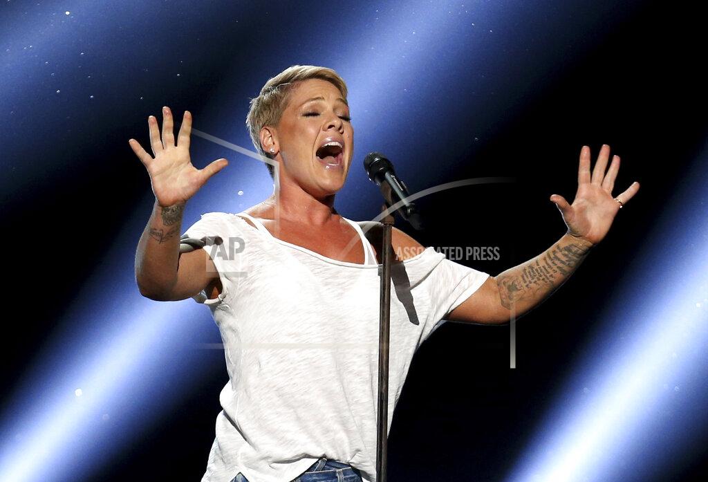 Matt Sayles FILE - In this Jan. 28, 2018, file photo, Pink performs "Wild Hearts Can't Be Broken" at the 60th annual Grammy Awards at Madison Square Garden in New York. We are all learning a lot about each other these days and that's especially true with our celebrities. Social distancing has meant they have no army of publicists or glam squad. While many influencers and stars continue to post a flood of flattering, carefully stage-managed images, others are mirroring us — unshaven, unwashed and not ashamed. “When I drink, I get really, really brilliant ideas,” the singer Pink confessed recently. "And last night, I got an idea — I can cut hair. I can totally cut hair. Why have I been paying people all this time?” She then reveals some choppy, shaved spots on her head. (Photo by Matt Sayles/Invision/AP, File)