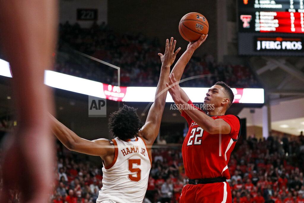 Brad Tollefson Texas Tech's TJ Holyfield (22) shoots the ball over Texas' Royce Hamm Jr. (5) during the second half of an NCAA college basketball game Saturday, Feb. 29, 2020, in Lubbock, Texas. (AP Photo/Brad Tollefson)