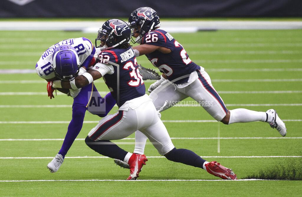 Eric Christian Smith Minnesota Vikings wide receiver Bisi Johnson (81) is hit by Houston Texans cornerback Lonnie Johnson (32) and cornerback Vernon Hargreaves III (26) after a catch during the second half of an NFL football game Sunday, Oct. 4, 2020, in Houston. (AP Photo/Eric Christian Smith)