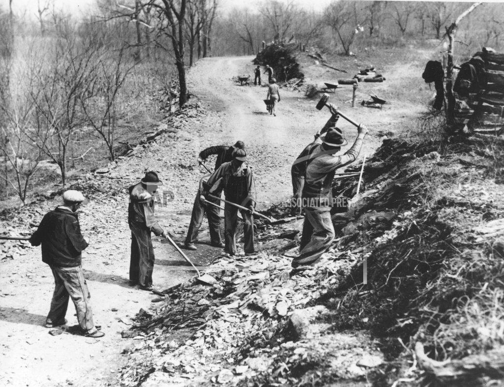 Anonymous FILE - In this March 9, 1936, file photo Works Progress Administration (WPA) workers build a new farm-to-market road along Knob Creek in Tennessee. The New Deal was a try-anything moment during the Great Depression that remade the role of the federal government in American life. (AP Photo, File)