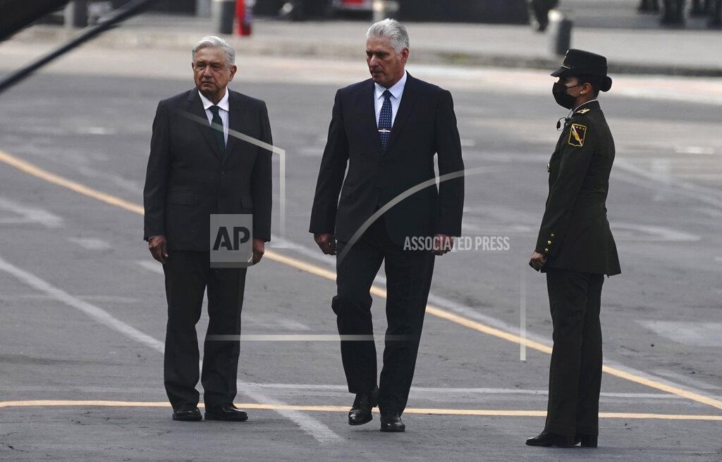 Marco Ugarte Cuba's President Miguel Diaz-Canel, center right, accompanies Mexico's President Andres Manuel Lopez Obrador, during Independence Day celebrations, in the Zocalo in Mexico City, Thursday, Sept. 16, 2021. (AP Photo/Marco Ugarte)
