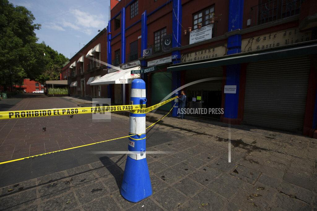 Fernando Llano A municipal employee closes off access to the main plaza of Coyoacan, in Mexico City, Saturday, April 4, 2020. Mexico has started taking tougher measures against the new coronavirus, but some experts warn the country is acting too late and testing too little to prevent the type of crisis unfolding across the border in the United States. (AP Photo/Fernando Llano)