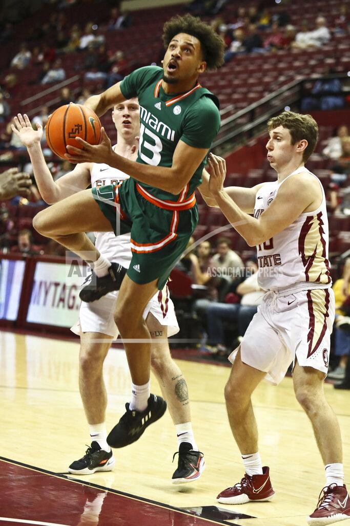 Phil Sears Miami guard Jakai Robinson (13) lunges towards the basket to make a layup past Florida State guards Tom House (12) and Isaac Spainhour (40) in the second half of an NCAA college basketball game in Tallahassee, Fla., Tuesday, Jan. 24, 2023. (AP Photo/Phil Sears)